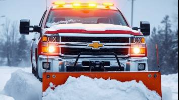 Snow plowing with a Chevy truck and yellow light on snowy roads and driveways.